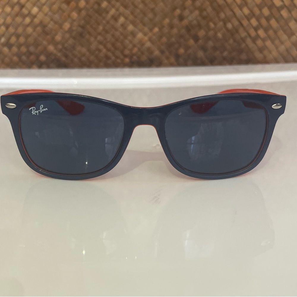 Authentic RAYBAN junior’s navy blue and orange sunglasses.